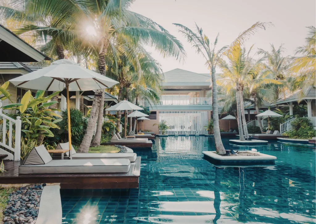 A boutique resort pool framed by tropical gardens