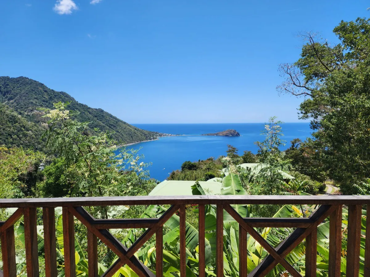The view over a wide blue bay from a hillside retreat in Dominica