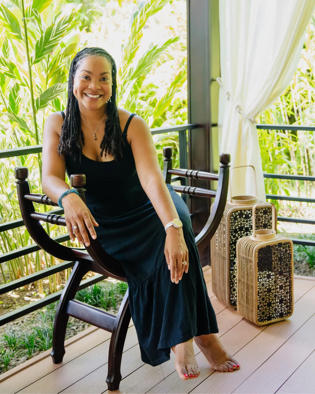 Kay Jones on a resort veranda in Costa Rica, surrounded by tropical plants