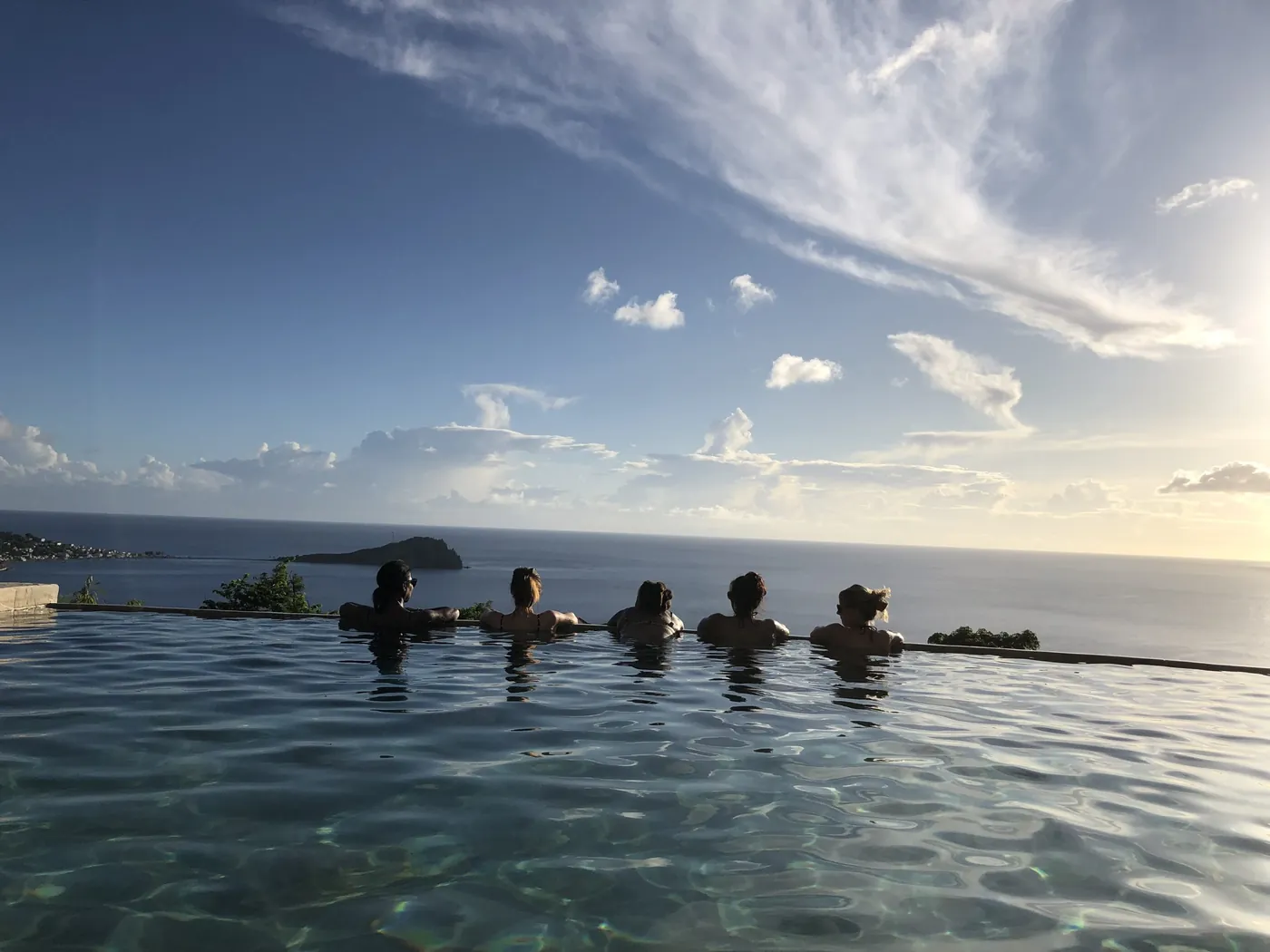 Retreat guests swimming together in a jungle pool
